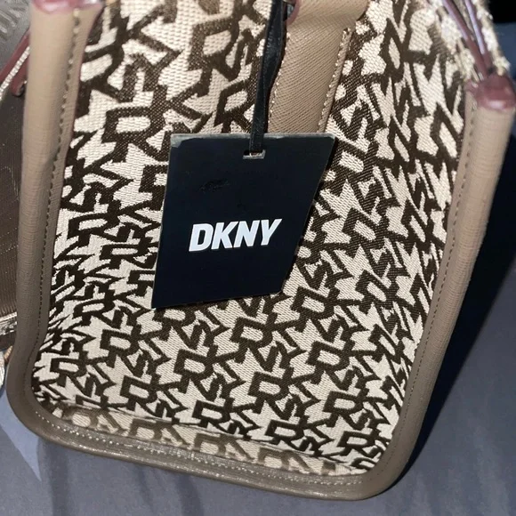 This bag is Tan and brown with a strap, one zipper, two pockets, space inside.